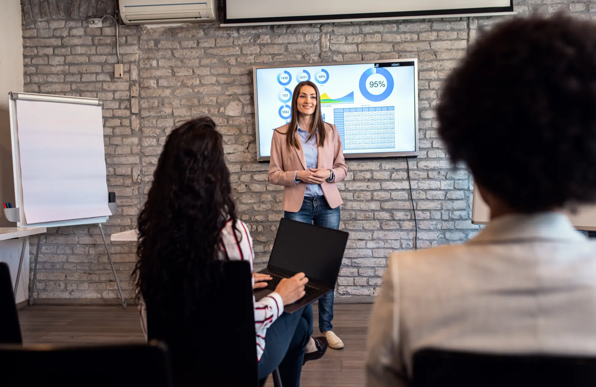 Businesswoman holding presentation to diverse group