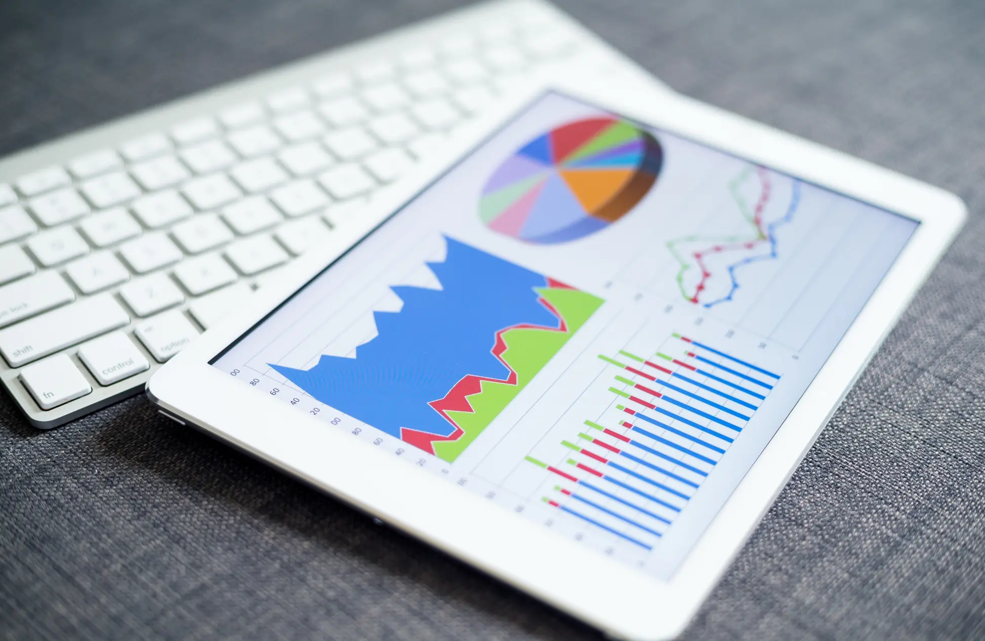 Business charts and diagrams on digital tablet