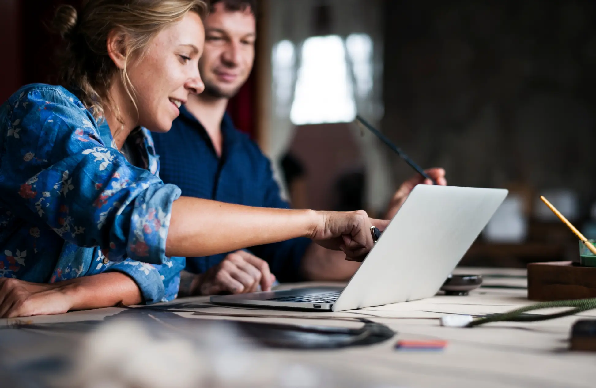 Woman poiting on computer laptop showing