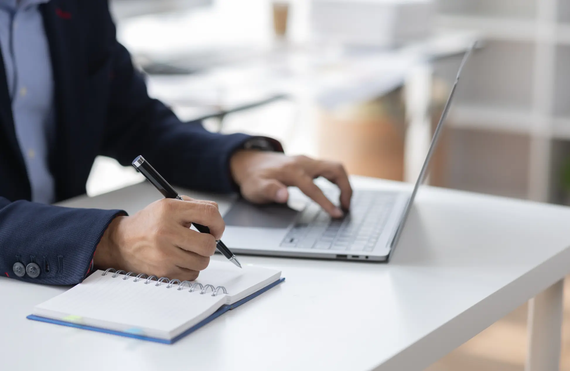 Hand of Asian businesswoman writing on paper note