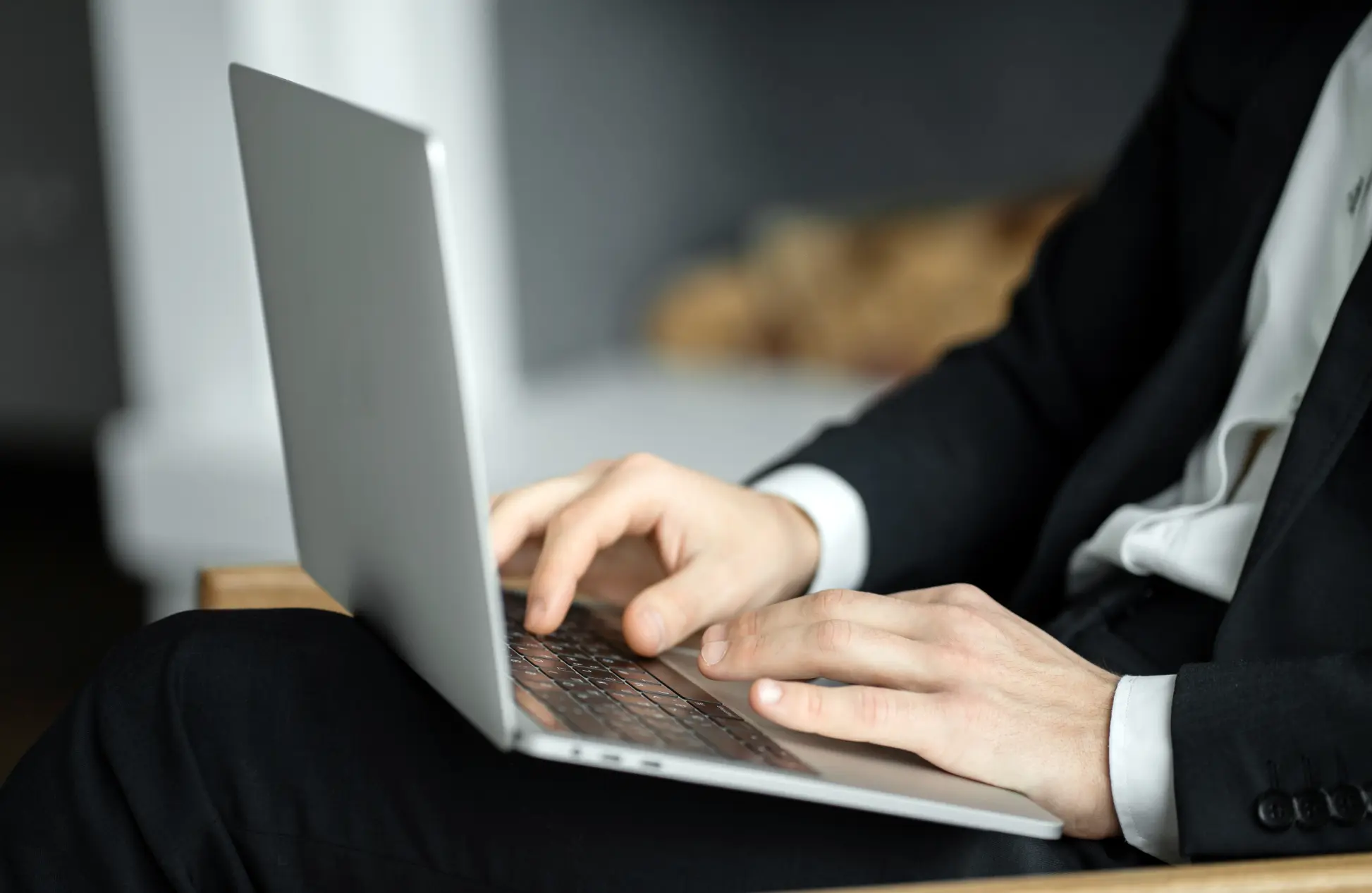 Businessman in formal suit uses a laptop